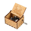 A vintage hand-cranked wooden music box with a lid featuring reindeer and Christmas text.