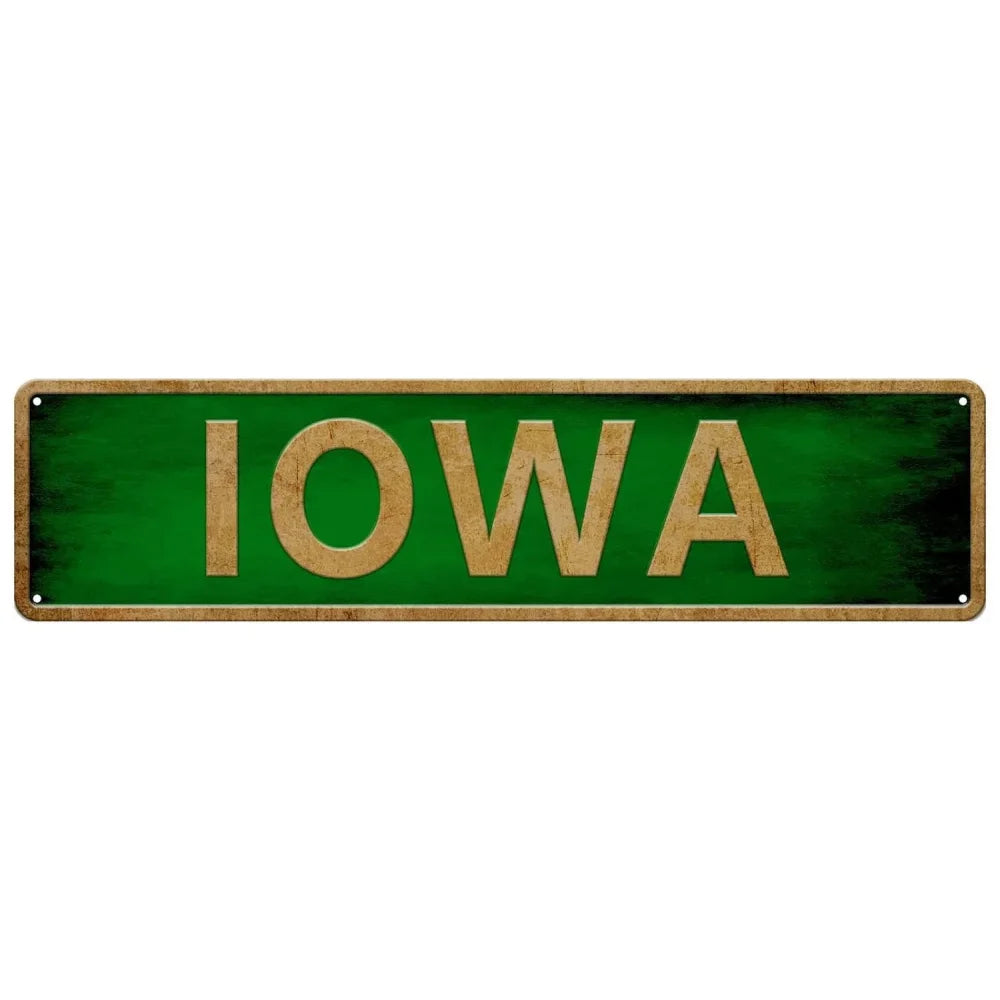 A rectangular green metal tin sign with the word IOWA written in gold letters.