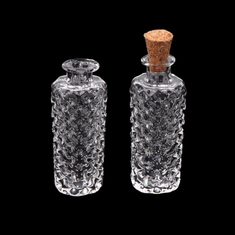 A pair of clear glass vessels, a vase and a bottle, with textured surfaces and cork stoppers.
