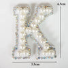 Alphabet letter K made of white pearls and rhinestones for clothing