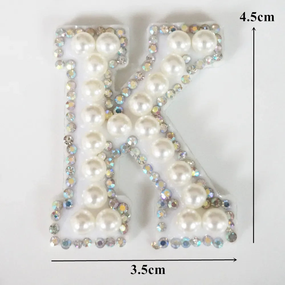Alphabet letter K made of white pearls and rhinestones for clothing