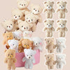 A collection of mini plush teddy bears in various shades of beige and white.