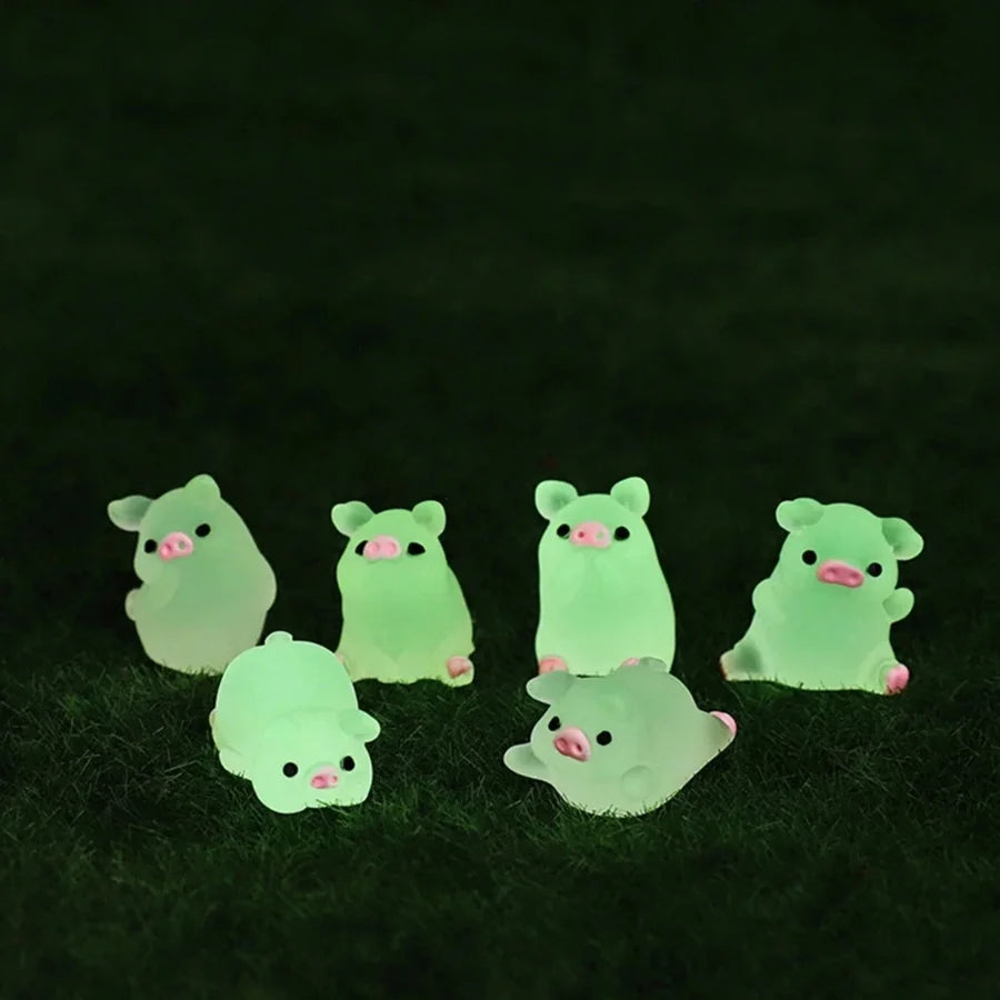 A group of glowing green mini pig figurines resting on a dark green surface.