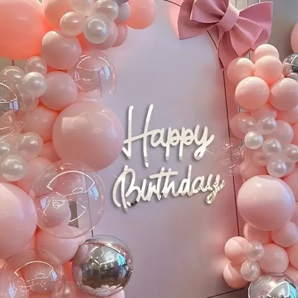 Pink and white balloon garland decor with Happy Birthday text on a white background