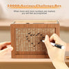 A hand marks numbers on a wooden savings box progress tracker to achieve a 1000 savings challenge.