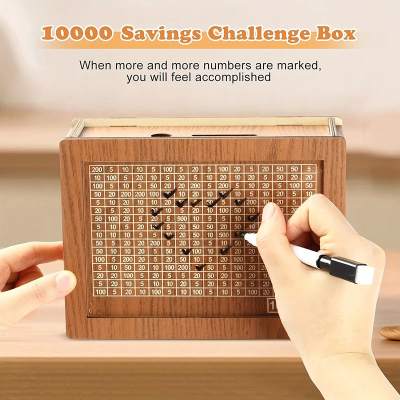 A hand marks numbers on a wooden savings box progress tracker to achieve a 1000 savings challenge.