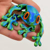 A realistic 3D frog fridge magnet with movable joints, colored in vibrant green and blue.