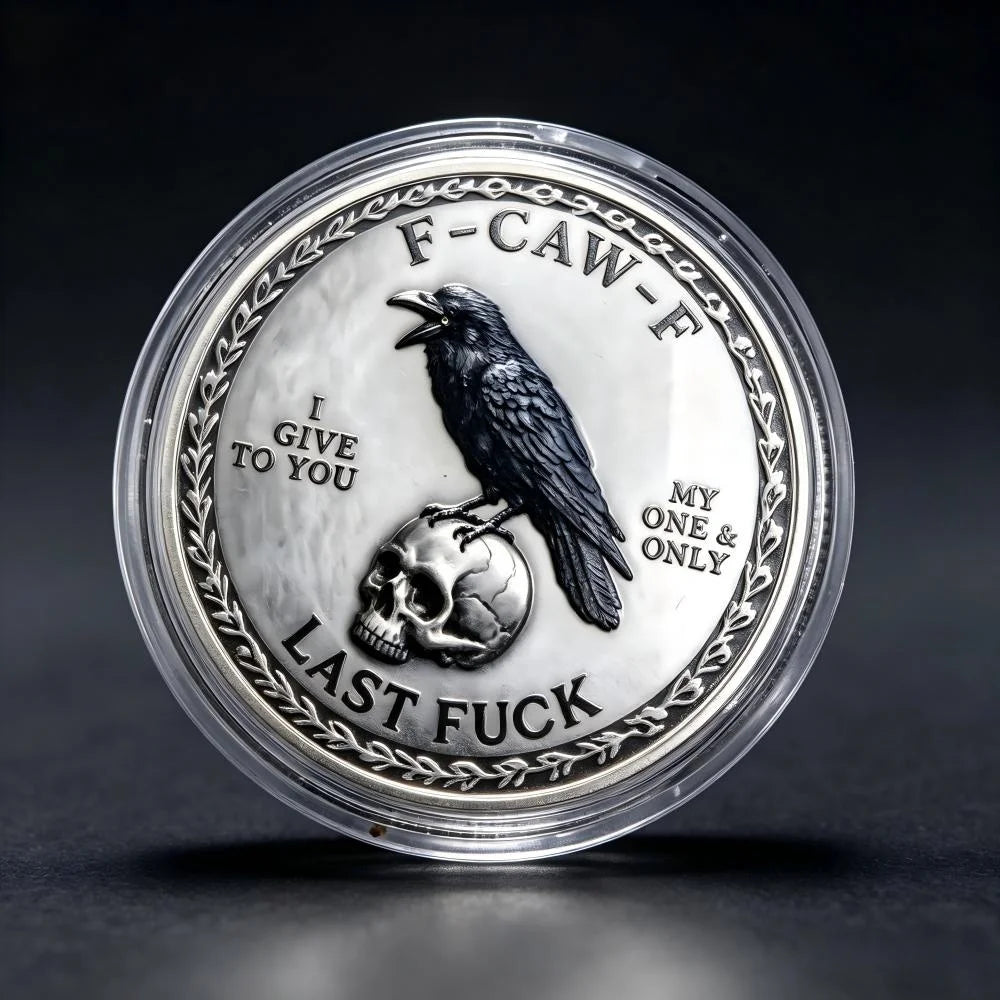 A silver challenge coin featuring a crow perched on a skull with the text Last Fuck