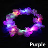Purple LED flower crown headband with glowing lights against a dark background