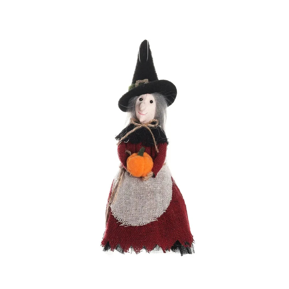 A scarecrow witch ornament set featuring a black pointed hat and a figure with gray skin and dark clothing.