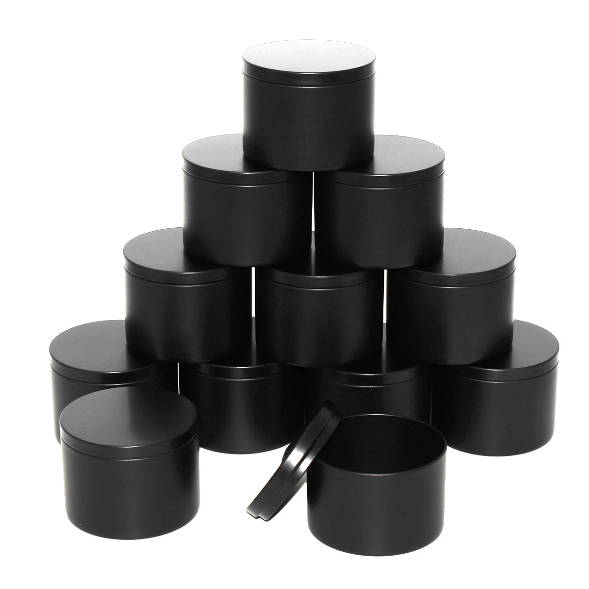 A stack of black metal candle tins with lids.