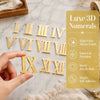 A set of gold Luxe 3D numerals in Roman numerals, including I through XIII, displayed on a marble surface.