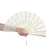 Elegant hollowout lace handheld fan with a delicate floral pattern being held by a hand