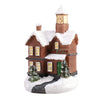 A festive Christmas house night light shaped like a brick building with snow on the roof and a clock tower.