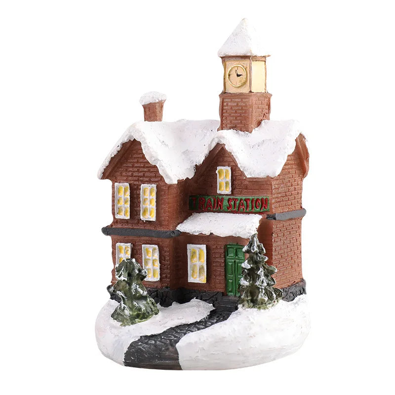 A festive Christmas house night light shaped like a brick building with snow on the roof and a clock tower.