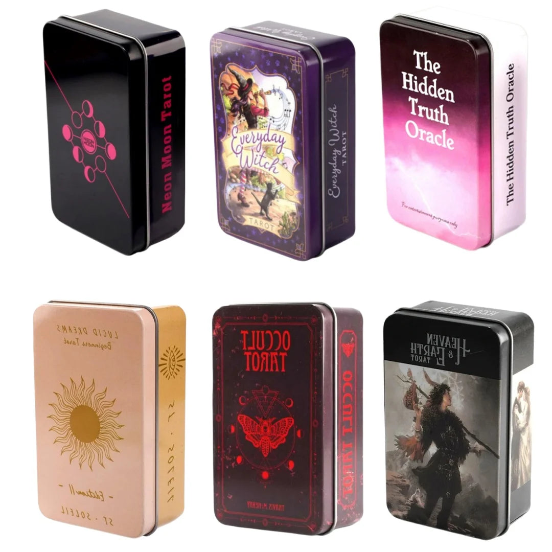A collection of vintage art tarot oracle cards in metal tins featuring various mystical imagery.