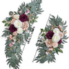 A floral kit featuring dusty rose and white roses with blue eucalyptus greenery for a wedding arch.