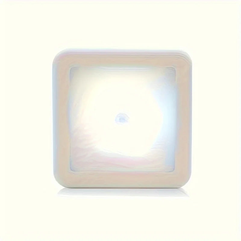 A square LED night light with a translucent white diffuser, designed for motion sensing.