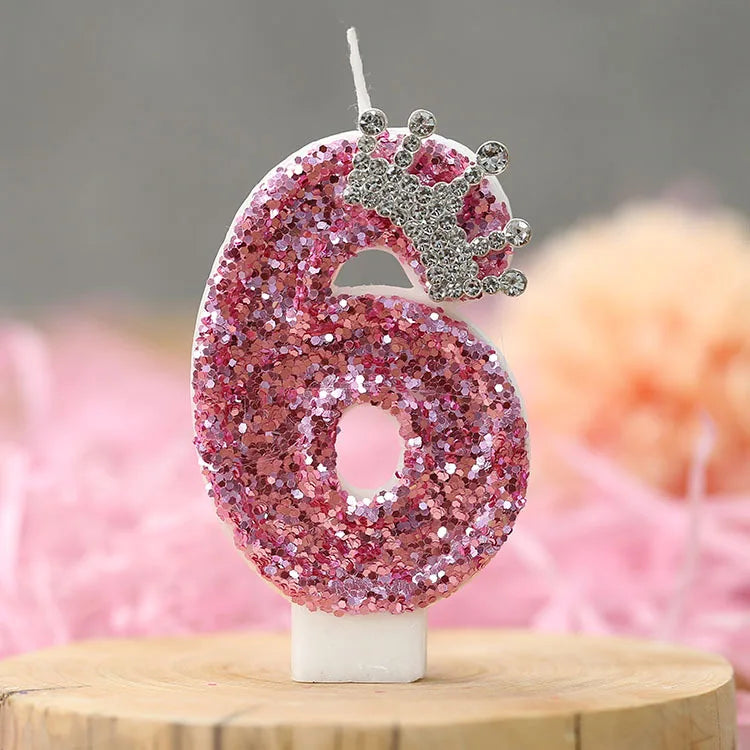 Pink glitter number six candle with a silver crown topper