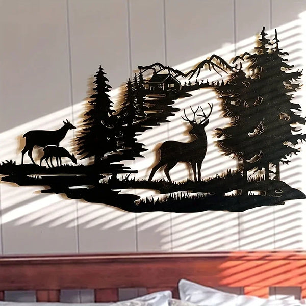 Black silhouette wall art depicting a deer standing in a forest landscape.