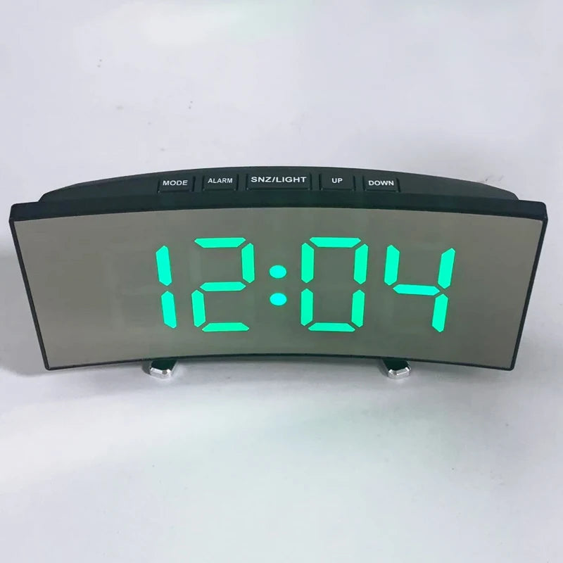 A digital LED alarm clock displaying 12:04 with mode buttons and a temperature display.