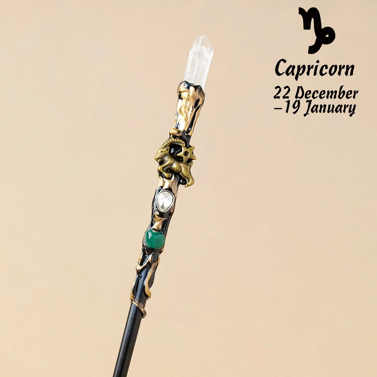 A natural clear quartz zodiac crystal wand with gold accents and a green bead, used for meditation and healing.