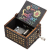 A vintage hand-cranked wooden music box with an open lid featuring the text You are my sunshine.