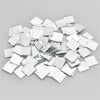 A pile of square and rectangular mirror tiles used for 3D mosaic wall decals.