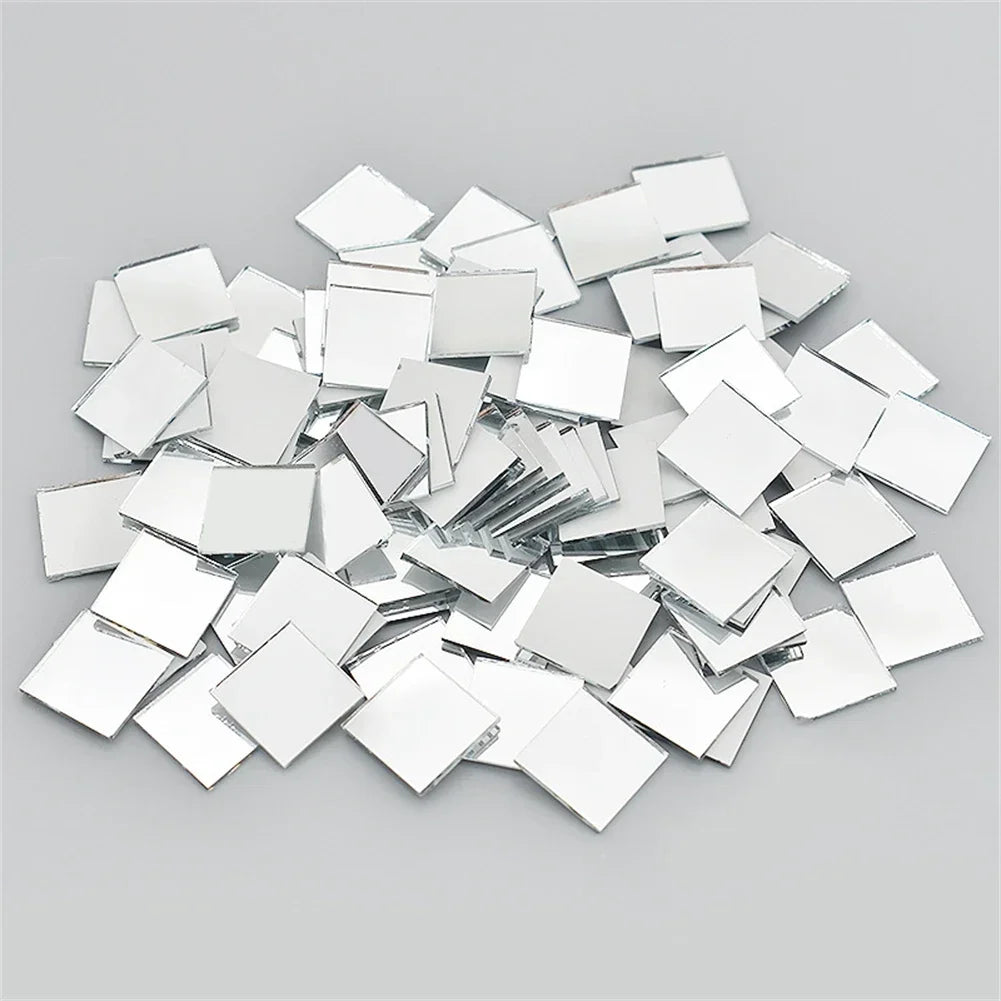 A pile of square and rectangular mirror tiles used for 3D mosaic wall decals.