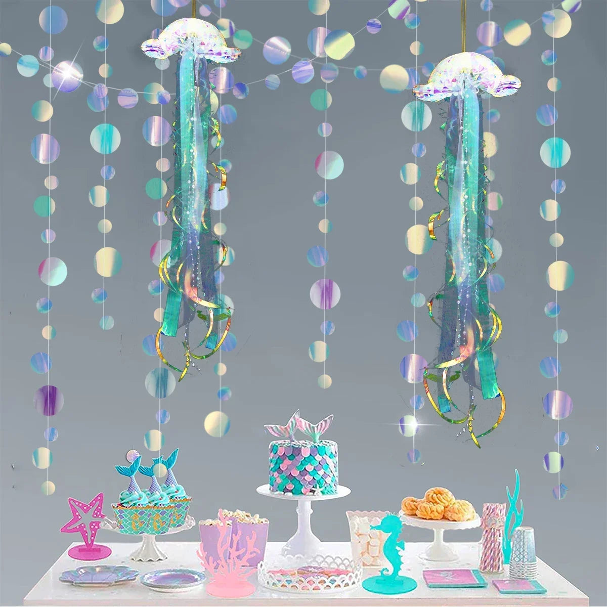 Iridescent mermaid and jellyfish party streamers hanging in a display with treats.