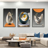 A set of three modern geometric canvas wall art pieces featuring abstract silver and blue tones displayed on a light gray wal