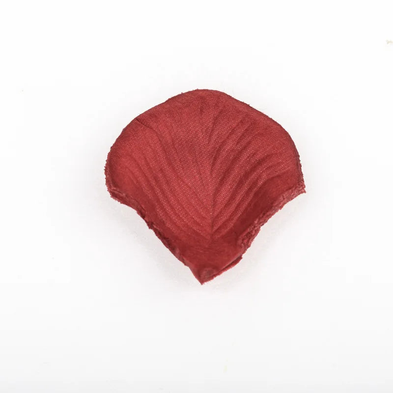 A single, deep reddish-brown artificial silk rose petal.