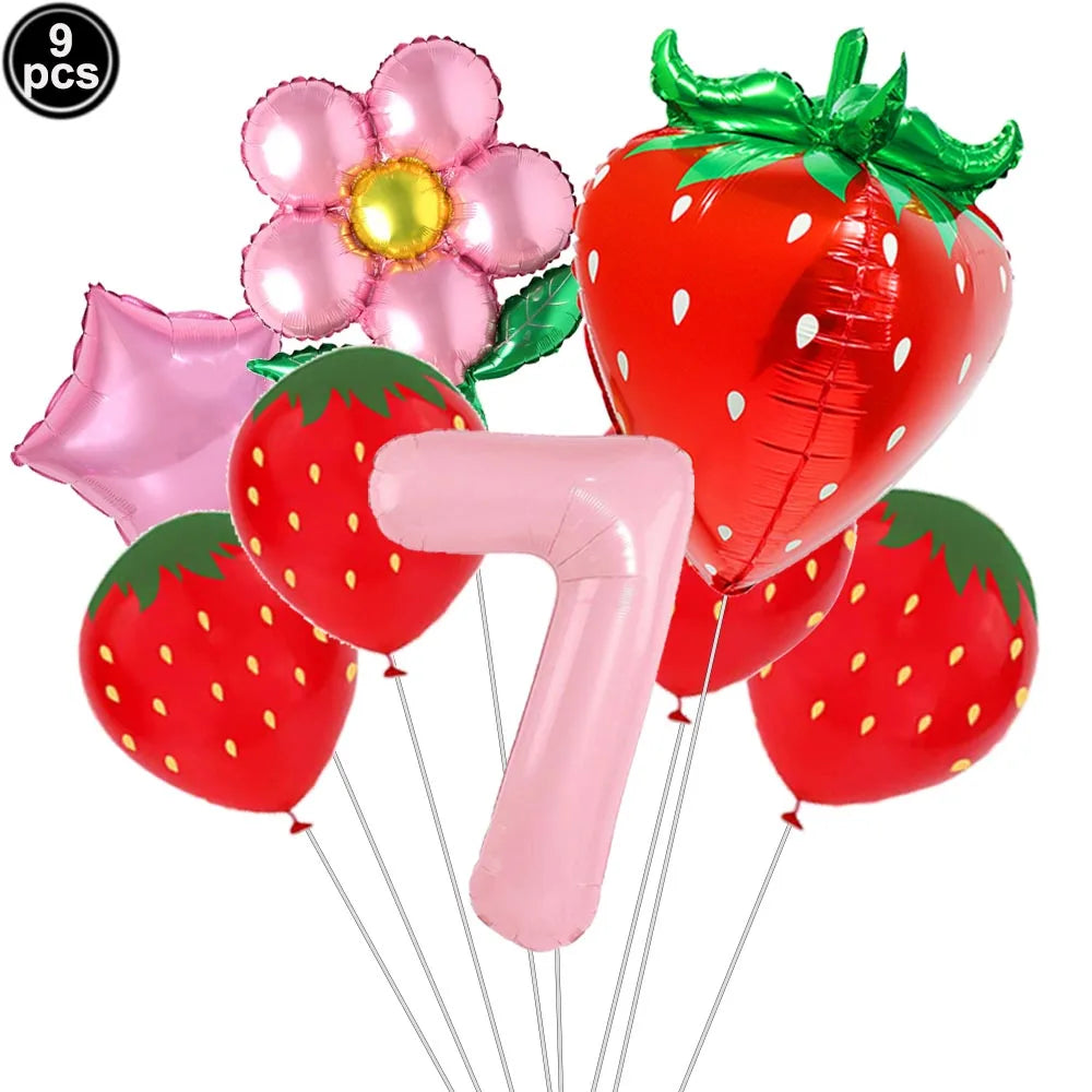 A set of nine pink and red strawberry-shaped balloons, including a large strawberry and a number balloon.