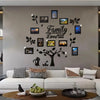 A modern living room wall decorated with a family tree collage of framed photos and leaves.