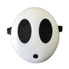 A white, round mask resembling a face with large black eye holes and a small black nose, used for cosplay or parties.