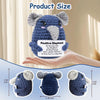 A handmade crochet elephant doll in blue and gray is shown being held by a hand, with size measurements provided.