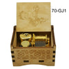 A wooden music box with a lid featuring an illustration of a character and a brass mechanism inside.