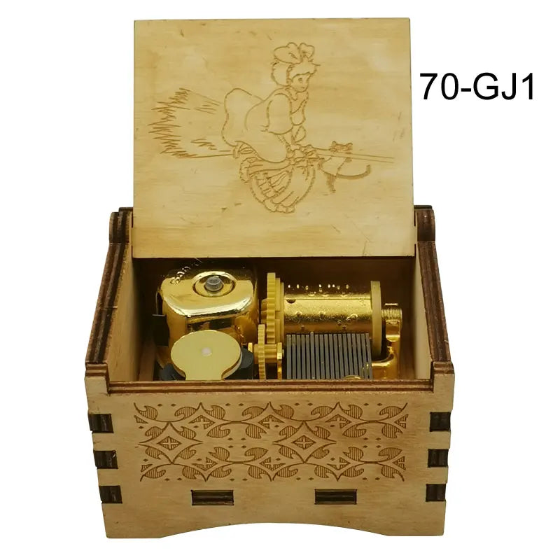 A wooden music box with a lid featuring an illustration of a character and a brass mechanism inside.
