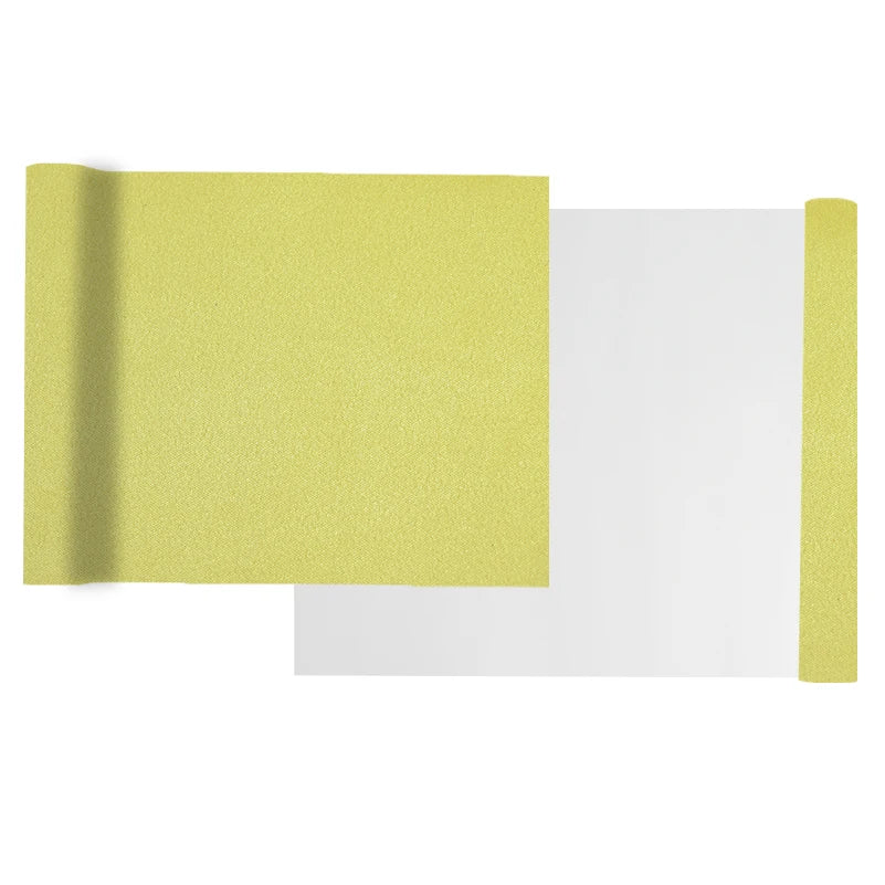 A sheet of yellow suede wrap fabric is shown next to a white piece of material.