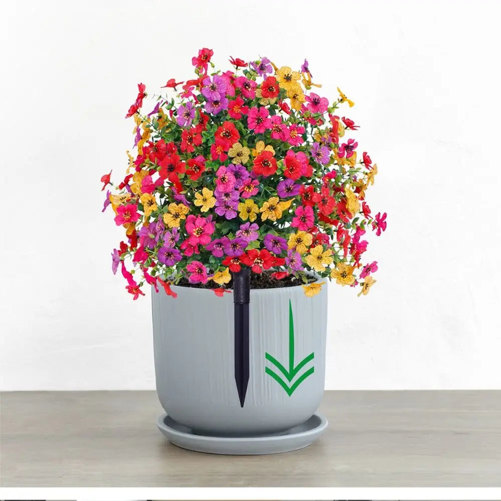 A potted artificial eucalyptus violet flower with vibrant pink, yellow, and red blooms on a gray ceramic pot.