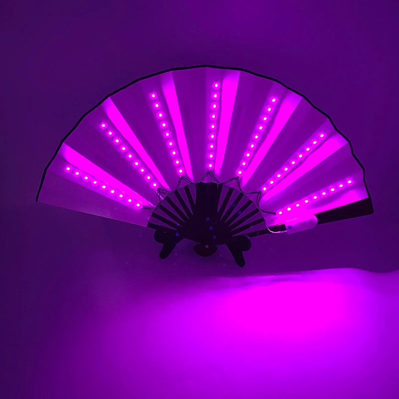 A multi-mode LED party fan with purple light shining on a wall.