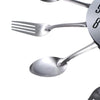A close-up view of modern stainless steel cutlery, including a fork and spoon, positioned near a clock face.