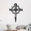 Black metal cross wall art featuring thorns and a pointed design displayed on a white wall.