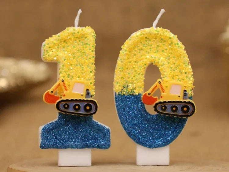 Two yellow construction excavator shaped birthday candles with blue glitter bases