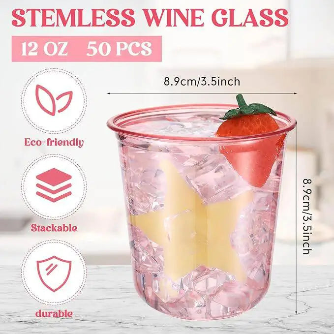 A clear pink disposable plastic wine glass filled with ice and garnished with a strawberry.