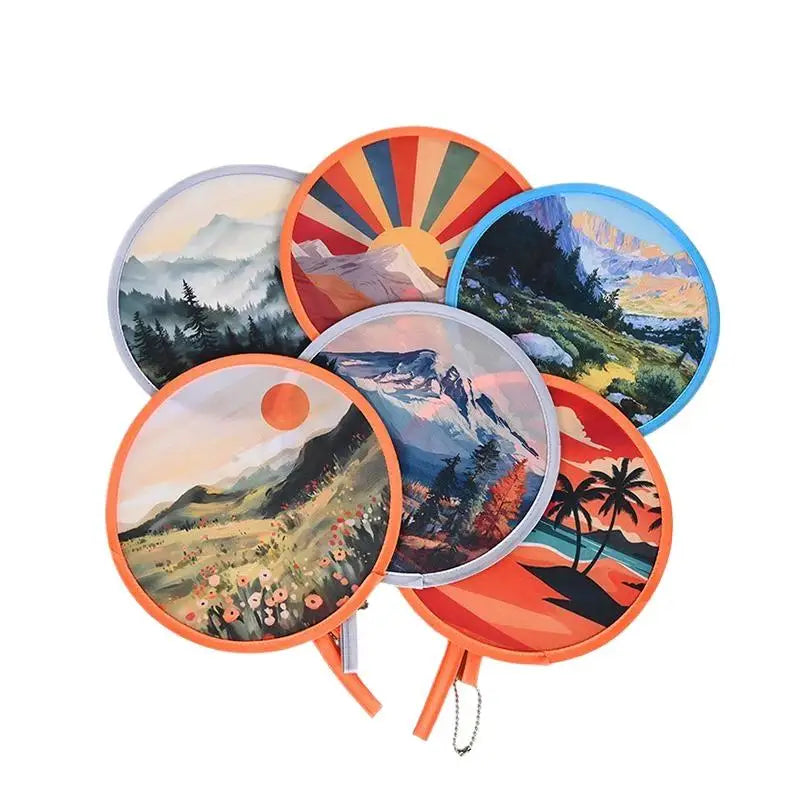 A collection of round, colorful, handheld cooling fans featuring scenic landscape designs.