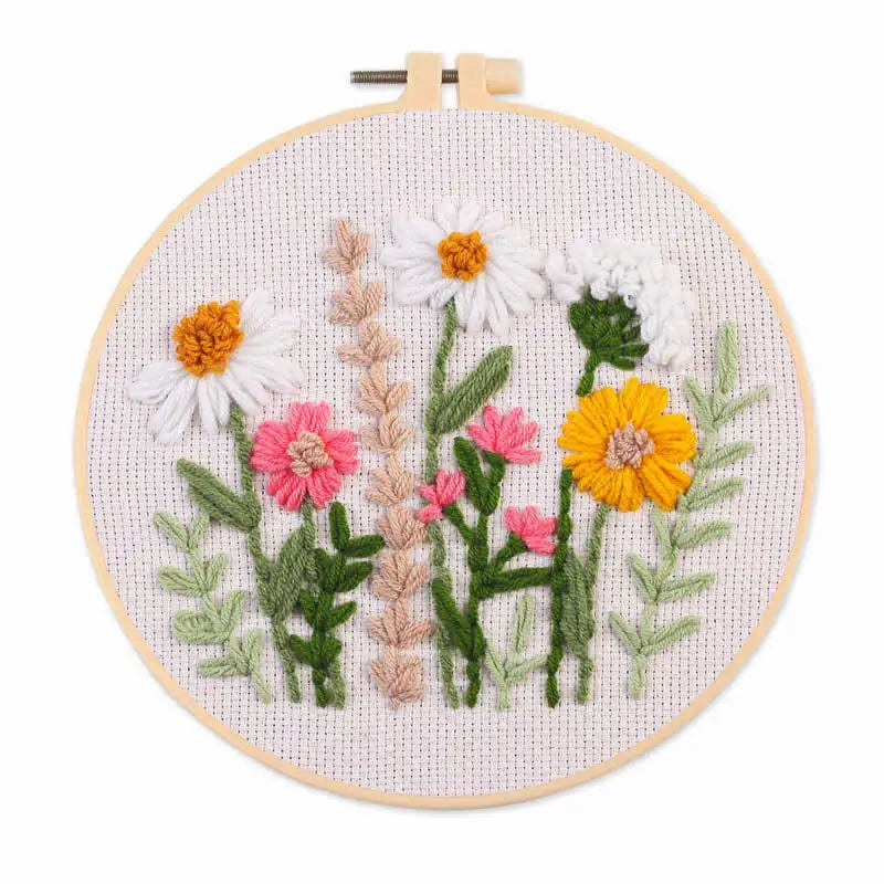Punch needle embroidery kit featuring floral designs on stamped cloth with tools