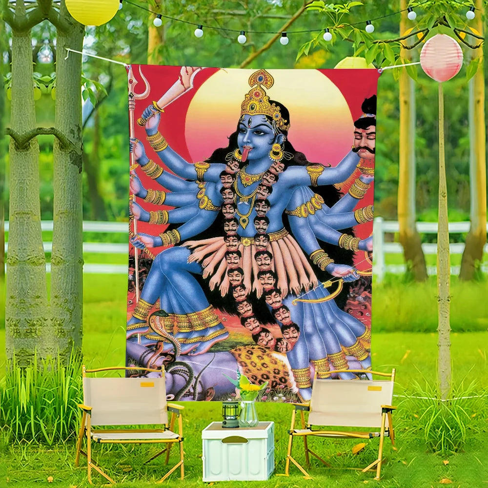 A vibrant wall art flag featuring a blue depiction of Maa Kali against an orange background, displayed outdoors in a garden s
