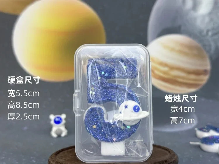 Clear plastic container holding a blue galaxy number birthday candle with a white planet design