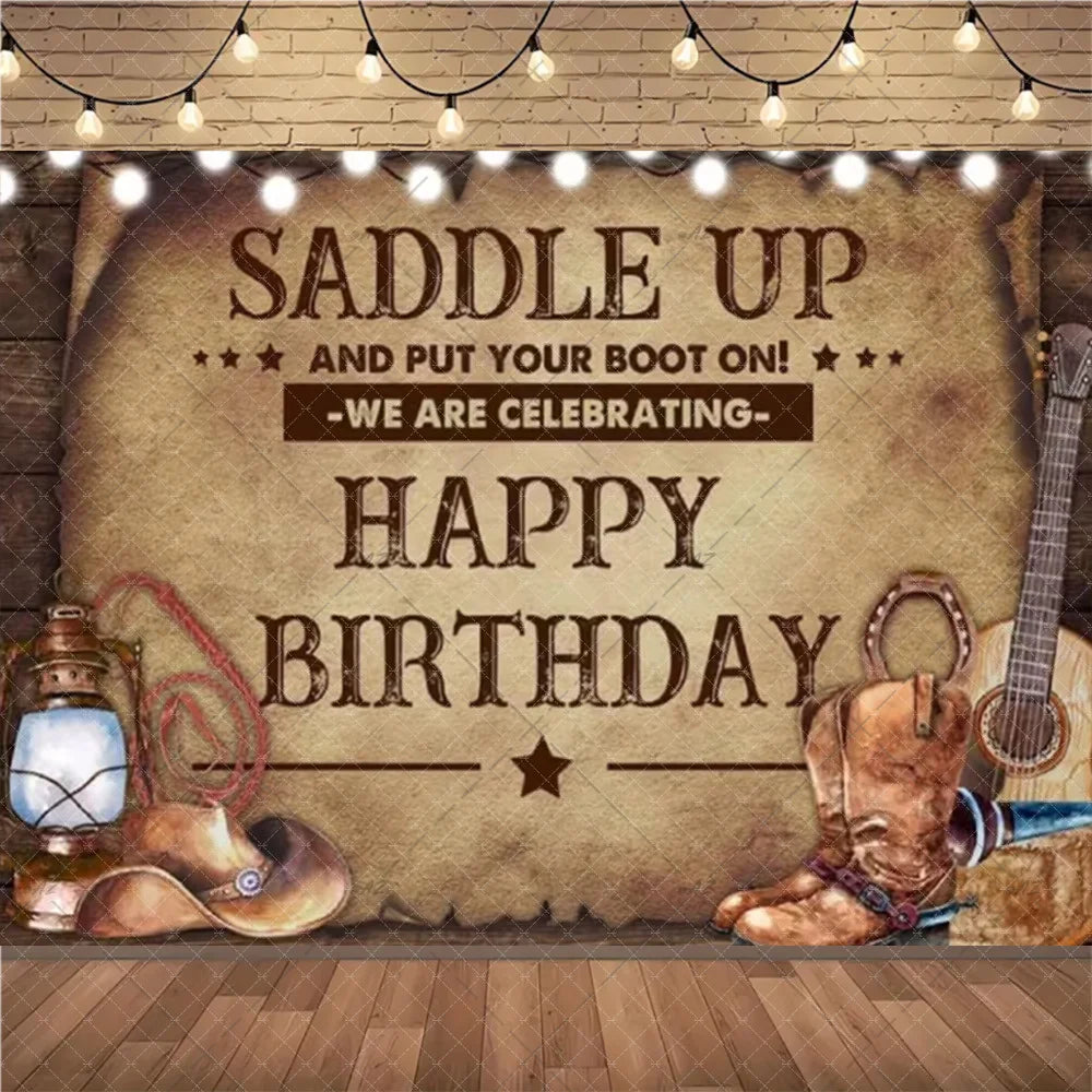A rustic wooden backdrop featuring a saddle, boots, and guitar with text wishing a happy birthday.